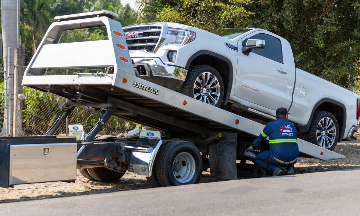 A tow truck on its way to a broken-down car